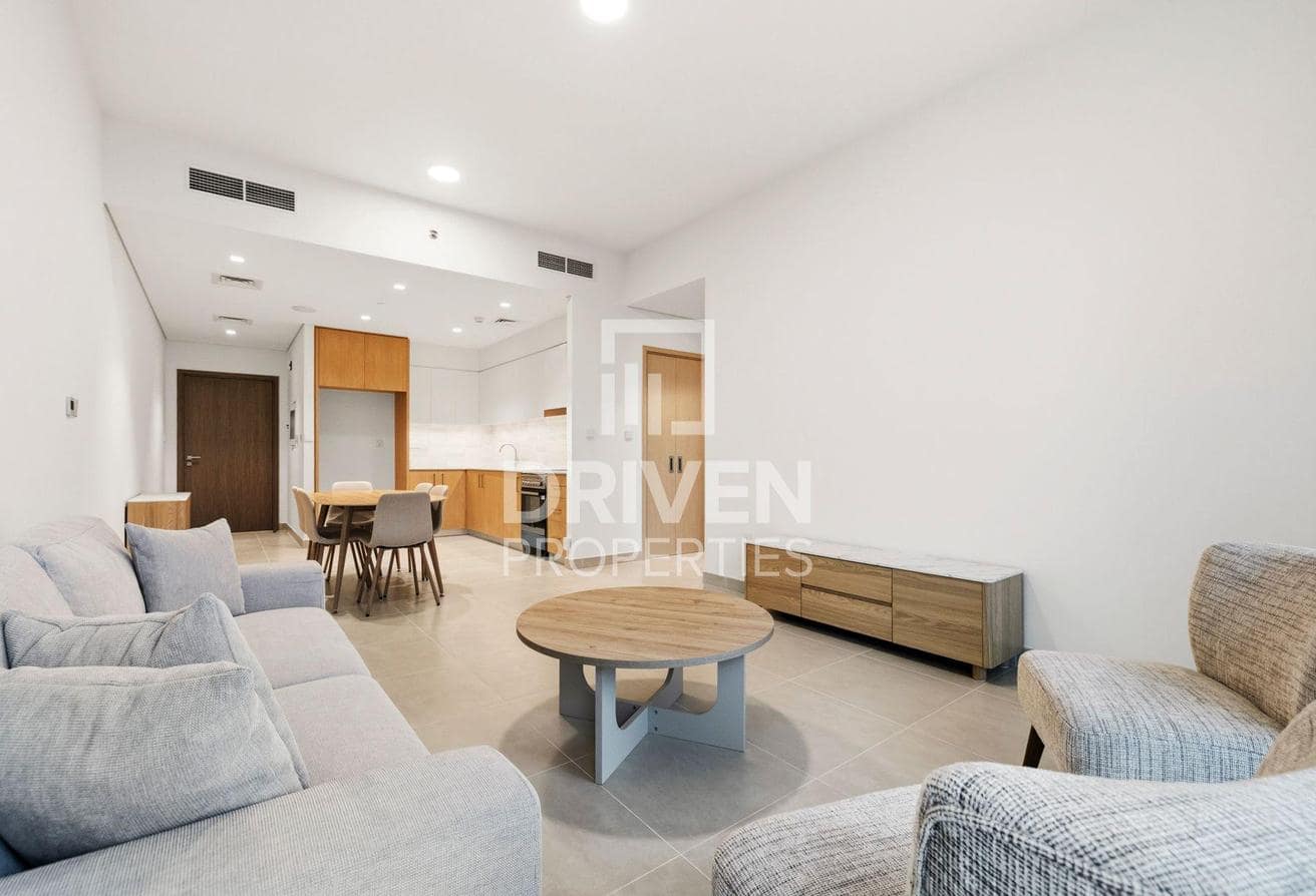 Mina Rashid listing photograph showing the furnished lounge and open kitchen